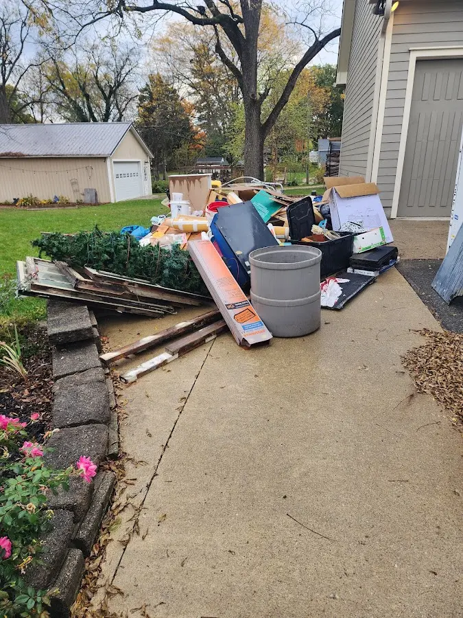 Dumpster being loaded with debris for 3 Yard Dumpster Rental in Herculaneum